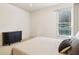 Bright bedroom with a window, blind, and dark cabinet at 2452 Stone Manor Ne Dr, Buford, GA 30519