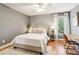 Bright bedroom with a queen bed, modern décor, and hardwood flooring at 2452 Stone Manor Ne Dr, Buford, GA 30519