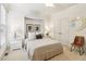 Bright bedroom with built-in bed frame, white trim, and circular wall mirror at 2452 Stone Manor Ne Dr, Buford, GA 30519