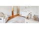Bright Bedroom with wood floors, white trim, dresser, and cozy chair at 2452 Stone Manor Ne Dr, Buford, GA 30519