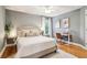 Comfortable bedroom featuring a queen-sized bed, a desk, and wood floors at 2452 Stone Manor Ne Dr, Buford, GA 30519