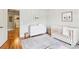 Bright Bedroom with wood floors, white trim, dresser, and crib at 2452 Stone Manor Ne Dr, Buford, GA 30519