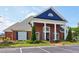 Attractive brick clubhouse featuring a blue gable, decorative columns, and well-kept landscaping at 2452 Stone Manor Ne Dr, Buford, GA 30519