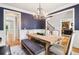 Dining room featuring dark blue accent wall, hardwood floors and rustic dining set at 2452 Stone Manor Ne Dr, Buford, GA 30519