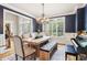 Dining room with rustic table, wood floors and a piano at 2452 Stone Manor Ne Dr, Buford, GA 30519