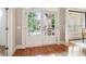 Grand foyer features hardwood flooring and a double glass paned front door at 2452 Stone Manor Ne Dr, Buford, GA 30519