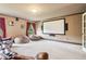 A media room with a movie screen, two windows, and a brown leather couch at 2452 Stone Manor Ne Dr, Buford, GA 30519