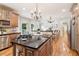 Spacious kitchen with an island, granite countertops, stainless appliances, and hardwood floors at 2452 Stone Manor Ne Dr, Buford, GA 30519