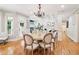 Bright kitchen/dining area with hardwood floors, large windows, and an open floor plan at 2452 Stone Manor Ne Dr, Buford, GA 30519