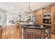 Open concept kitchen featuring a central island with cooktop and view of the living area at 2452 Stone Manor Ne Dr, Buford, GA 30519