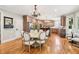 Eat-in kitchen with a dining table, custom cabinetry, stainless steel appliances, and hardwood flooring at 2452 Stone Manor Ne Dr, Buford, GA 30519
