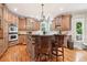 Gourmet kitchen features custom cabinetry, a center island with seating, and stainless steel appliances at 2452 Stone Manor Ne Dr, Buford, GA 30519