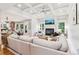 Bright living room featuring a fireplace, coffered ceilings, and a large sectional sofa at 2452 Stone Manor Ne Dr, Buford, GA 30519