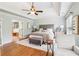 Spacious main bedroom suite featuring a tray ceiling, hardwood floors, sitting area, and an ensuite bathroom at 2452 Stone Manor Ne Dr, Buford, GA 30519