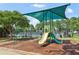 Community playground with slides and play equipment with a sun shade on a mulch base at 2452 Stone Manor Ne Dr, Buford, GA 30519