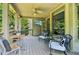 Relax on the screened porch with ample seating, a ceiling fan, and a TV for outdoor enjoyment at 2452 Stone Manor Ne Dr, Buford, GA 30519