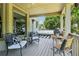 Relaxing screened porch boasts plenty of seating and views of the backyard landscaping and mature trees at 2452 Stone Manor Ne Dr, Buford, GA 30519