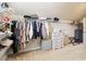 Walk-in closet with custom shelving providing storage for clothing, shoes, and accessories at 2452 Stone Manor Ne Dr, Buford, GA 30519
