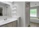 Bathroom with single sink vanity, tile flooring, separate shower and soaking tub at 3196 Windfield Cir, Tucker, GA 30084