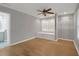 Bedroom featuring hardwood flooring, a ceiling fan, a built in bench and closet storage at 3196 Windfield Cir, Tucker, GA 30084