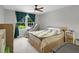 Bright bedroom featuring large window with curtains, a queen size bed, and sitting chair at 3196 Windfield Cir, Tucker, GA 30084