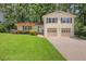 Charming home with a well-manicured lawn, covered porch, and two-car garage at 3196 Windfield Cir, Tucker, GA 30084