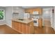 View of kitchen with wooden cabinets, laminate countertops, white appliances, and hardwood flooring at 3196 Windfield Cir, Tucker, GA 30084