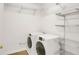 Bright laundry area with modern washer and dryer, wire shelving and ample storage space at 3196 Windfield Cir, Tucker, GA 30084