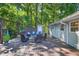 Inviting backyard deck with ample seating, perfect for outdoor gatherings and relaxing in the serene, natural environment at 6077 Lake Lanier Heights Rd, Buford, GA 30518