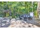 Spacious deck with comfortable seating and serene backyard views, perfect for relaxing and entertaining guests outdoors at 6077 Lake Lanier Heights Rd, Buford, GA 30518