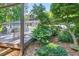Outdoor deck and lush greenery provide a private and tranquil space for relaxing and enjoying the natural surroundings at 6077 Lake Lanier Heights Rd, Buford, GA 30518