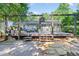 Multi-level backyard with spacious deck and stone patio, ideal for outdoor entertaining and enjoying the private, serene setting at 6077 Lake Lanier Heights Rd, Buford, GA 30518