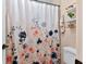 Bathroom with a patterned shower curtain and a view of floating shelves at 6077 Lake Lanier Heights Rd, Buford, GA 30518