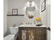 Updated powder room featuring a modern vanity, stylish mirror, and elegant fixtures at 6077 Lake Lanier Heights Rd, Buford, GA 30518