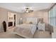 Cozy bedroom with plush carpeting, white furniture, and view to ensuite bath at 6077 Lake Lanier Heights Rd, Buford, GA 30518