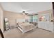 Bright bedroom featuring a ceiling fan, dresser, plush carpet, and natural light at 6077 Lake Lanier Heights Rd, Buford, GA 30518