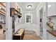 Welcoming entry hall with a storage bench and access to the living room, kitchen and bathroom at 6077 Lake Lanier Heights Rd, Buford, GA 30518