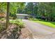 Charming home with a two-car garage, well-kept lawn, mature trees, and inviting landscaping at 6077 Lake Lanier Heights Rd, Buford, GA 30518