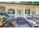 Charming front porch featuring hanging flower baskets and quaint decor, adding to the home's appeal at 6077 Lake Lanier Heights Rd, Buford, GA 30518