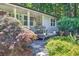 Inviting front porch with lovely flower baskets and a cozy seating area amidst lush greenery at 6077 Lake Lanier Heights Rd, Buford, GA 30518