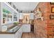 Cozy bar area with granite counters, brick accents, and wine refrigerator at 6077 Lake Lanier Heights Rd, Buford, GA 30518