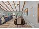 Open-concept living room featuring exposed wood beams, ceiling fans, wood floors, and a dining area at 6077 Lake Lanier Heights Rd, Buford, GA 30518