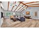 Expansive living room featuring vaulted ceilings, wooden beams, and a comfortable seating area with natural light at 6077 Lake Lanier Heights Rd, Buford, GA 30518