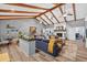 Spacious living room with vaulted ceilings, exposed beams, and a cozy fireplace, creating a warm and inviting atmosphere at 6077 Lake Lanier Heights Rd, Buford, GA 30518