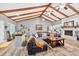 Bright living room with high ceilings and wood beams, complete with a cozy fireplace and stylish decor at 6077 Lake Lanier Heights Rd, Buford, GA 30518