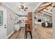 Open-concept kitchen and living room with exposed beam ceilings and hardwood floors at 6077 Lake Lanier Heights Rd, Buford, GA 30518