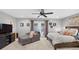 Bright main bedroom features sitting area, ceiling fan, and patio door at 6077 Lake Lanier Heights Rd, Buford, GA 30518