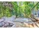 Charming patio with stone and brick, offering a relaxing outdoor space amidst serene, private, and verdant surroundings at 6077 Lake Lanier Heights Rd, Buford, GA 30518