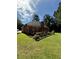 Beautifully landscaped backyard featuring a wooden deck and a well-manicured lawn at 709 Stonehenge Pl, Jonesboro, GA 30236