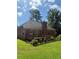 Back exterior showcasing a charming wooden deck and lush backyard at 709 Stonehenge Pl, Jonesboro, GA 30236